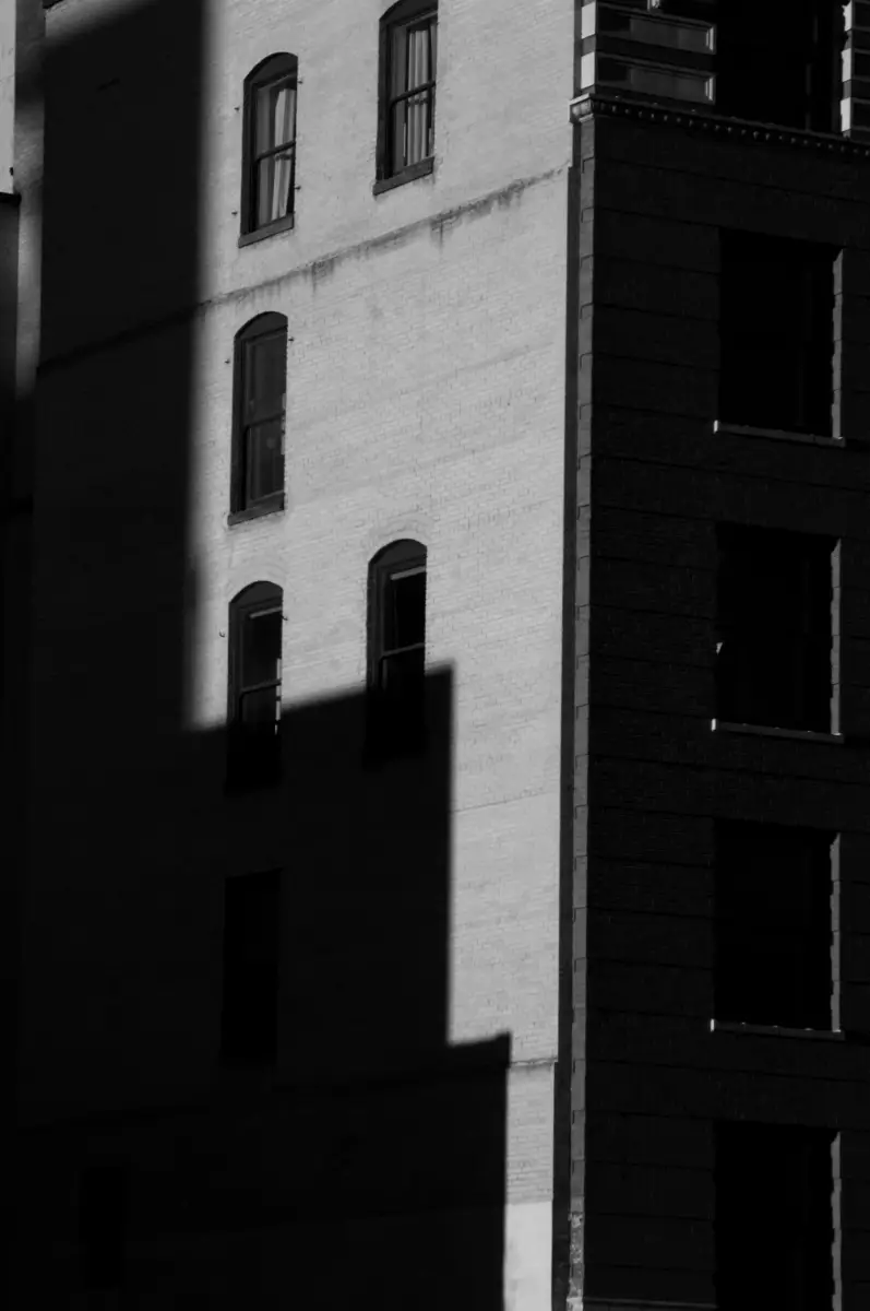 Photo of the shadow of one building cast onto another